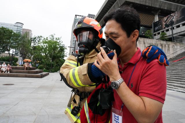 A firefighter rescues a citizen during Seouls earthquake response drill at Sejong Center for the Performing Arts next to Gwanghwamun Plaza on July 29 2024 AJU PRESS Park Jong-hyeok