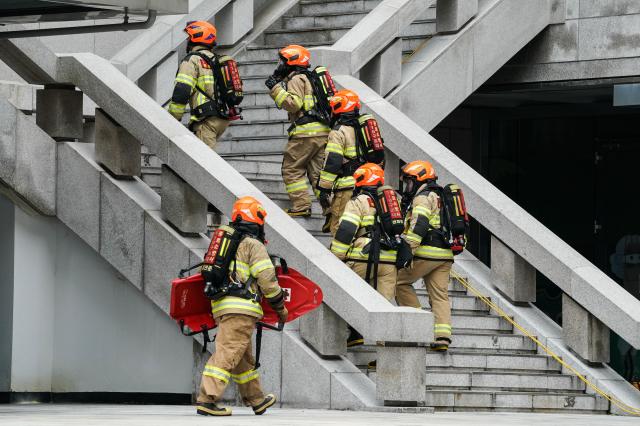 Firefighters enter the building during Seouls earthquake response drill at Sejong Center for the Performing Arts next to Gwanghwamun Plaza on July 29 2024 AJU PRESS Park Jong-hyeok