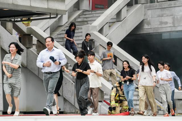 Citizens participate in an evacuation drill during Seouls earthquake response drill at Sejong Center for the Performing Arts next to Gwanghwamun Plaza on July 29 2024 AJU PRESS Park Jong-hyeok