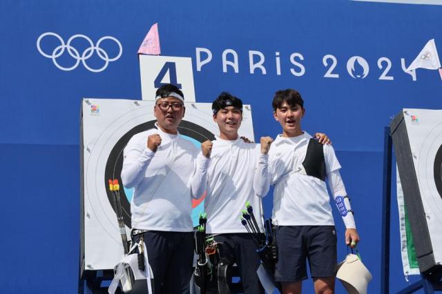 Archers Kim Woo-jin far left Lee Woo-seok center and Kim Je-deok pose for a photo after finishing the mens individual round at the Paris Olymics in France on July 25 2024 Yonhap