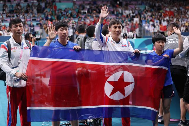 Lim Jong-hoon L and Shin Yu-bin R wave hands after clinched bronze in the mixed doubles table tennis event at the  Paris Olympics in France on July 30 2024 Yonhap