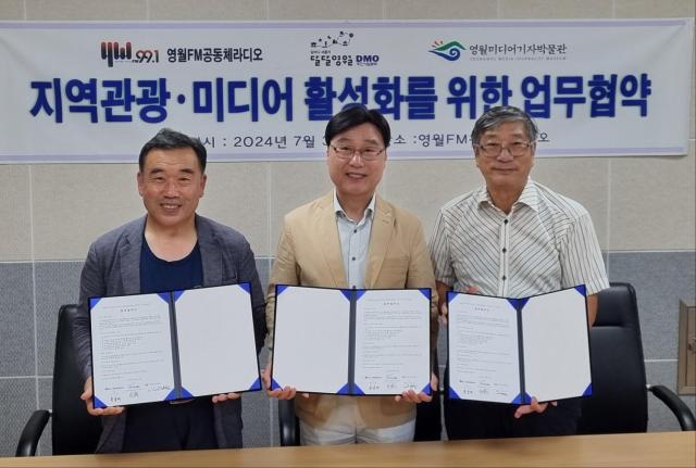 Yeongwol FM Director Hong Sung-rae left Daldal Yeongwol DMO President Park Sang-heon center and Yeongwol Museum of Media and Journalism head Koh Myung-jin right pose for a photograph in Yeongwol on July 31 Courtesy of Daldal Yeongwol DMO 