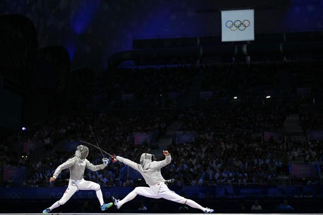 Do Gyeong-dong R competes against Hungarys Krisztian Rabb in the mens sabre team gold medal bout between Hungary and South Korea at the Paris Olympics in France August 1 2024 AFP-Yonhap