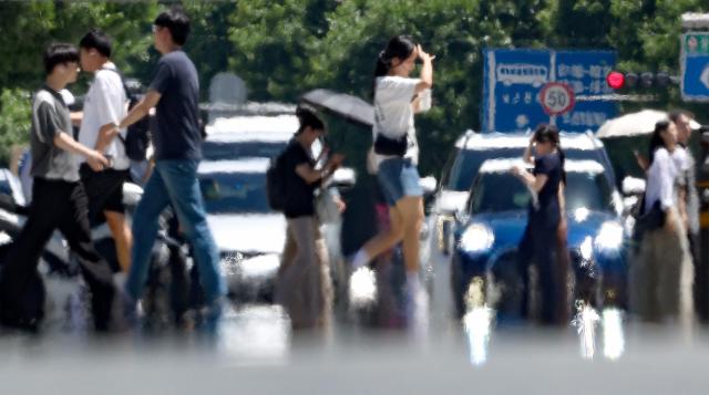 Citizens pass through a road with heatwaves rising in Daegu Korea on 29th July 2024 Yonhap