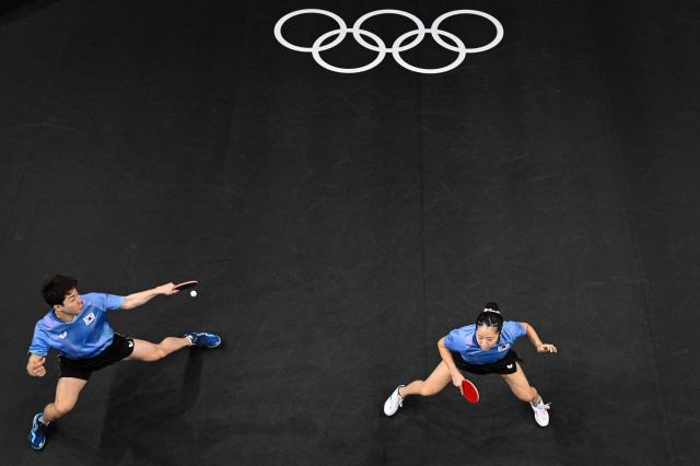 Lim Jong-hoon and Shin Yu-bin compete against Hong Kongs Wong Chun Ting and Doo Hoi Kem in the mixed doubles table tennis final at the Paris Olympics in France July 30 2024 AFP-Yonhap