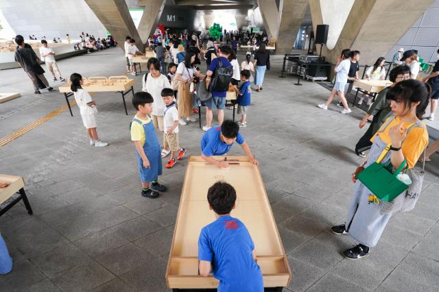 Children play wooden table games at the 2024 Seoul City Picnic which opened on Aug 1 at the DDP in Seoul AJU PRESS Park Jong-hyeok