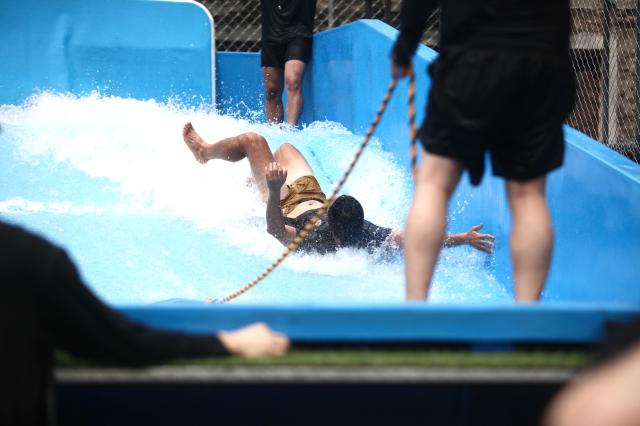 A man falls while surfing at the PUBG pop-up store PUBG Seongsu in Seongsu-dong Seoul on August 1 2024 AJU PRESS Han Jun-gu