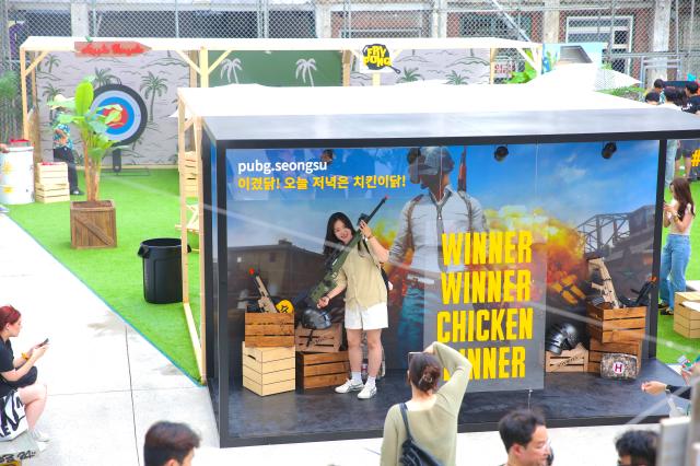 A visitor poses for a photo at the PUBG pop-up store PUBG Seongsu in Seongsu-dong Seoul on August 1 2024 AJU PRESS Han Jun-gu