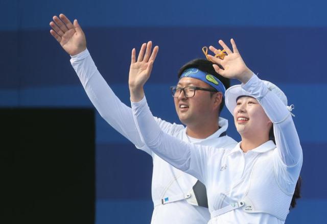 Archers Kim Woo-jin and Lim Si-hyeon react after wrapping up an individual elimination round at the Summer Olympics in Paris France on Aug 2 2024 Yonhap