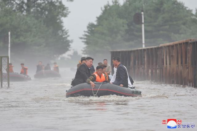 North Korean leader Kim Jong-un without wearing a life jacket inspects a flooded area on a speedboat in this report published on Aug 1 2004 in North Korea AP