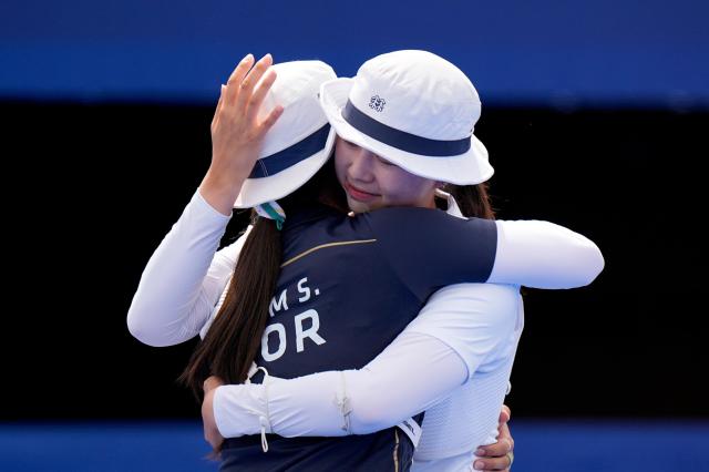 South Koreas Lim Si-hyeon right hugs teammate Nam Su-hyeon after Lim defeated her in the womens archery individual gold medal match at the Paris Summer Olympics Saturday Aug 3 2024 AP-Yonhap