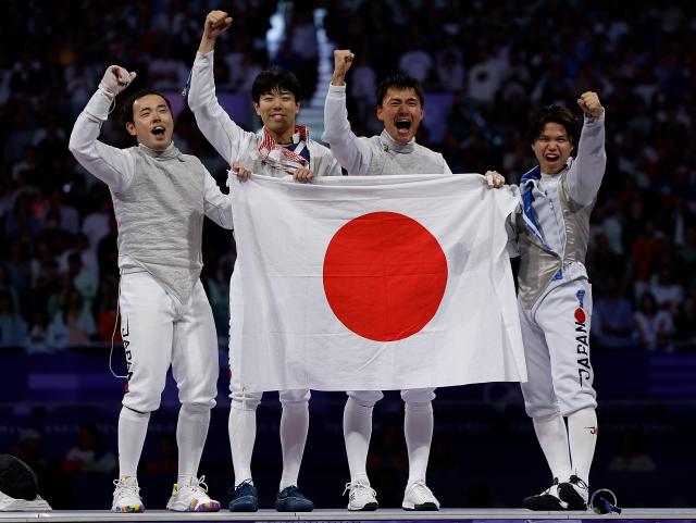 Team Japan celebrates victory after the mens foil team gold medal match of fencing between Italy and Japan at the Paris 2024 Olympic Games Aug 4 2024 Yonhap photo