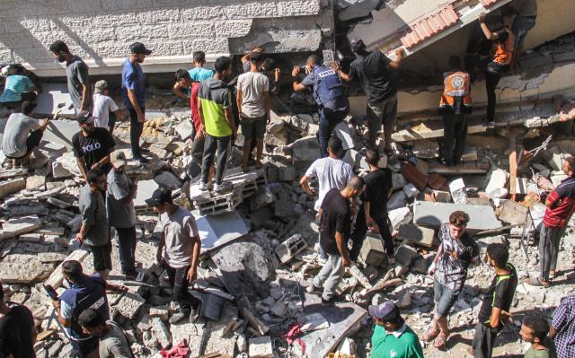 People look for victims at a school that was damaged by Israeli airstrikes in Gaza City Aug 4 2024 