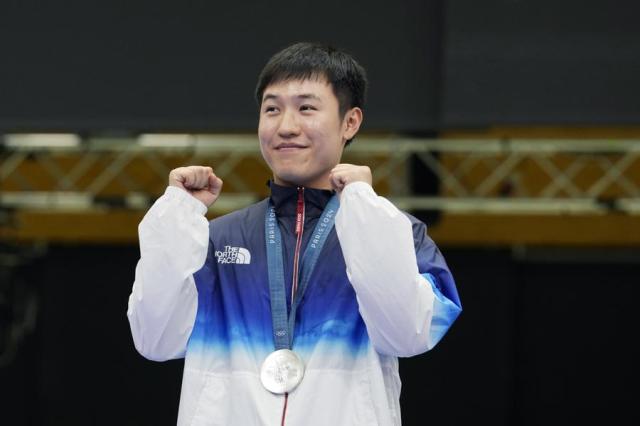 Shooter Cho Yeong-jae poses for a photo after winning silver in the mens 25-meter rapid fire pistol at the Summer Olympics in Paris France on Aug 5 2024 AP-Yonhap