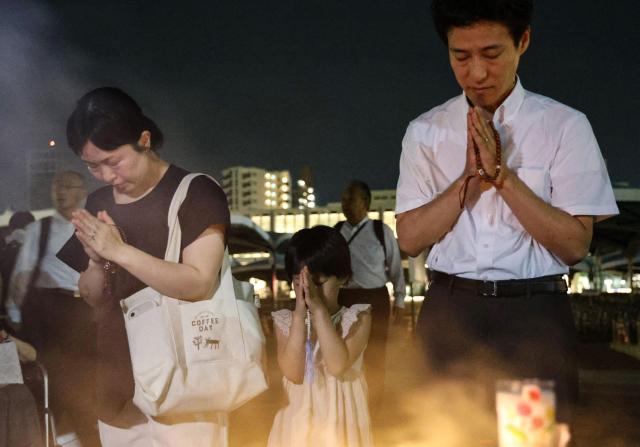 People pray at the Cenotaph for the Atomic Bomb Victims at the Peace Memorial Park in Hiroshima on the 79th anniversary of the atomic bomb tragedy on Aug 6 2024 JIJI Press  AFP - Yonhap