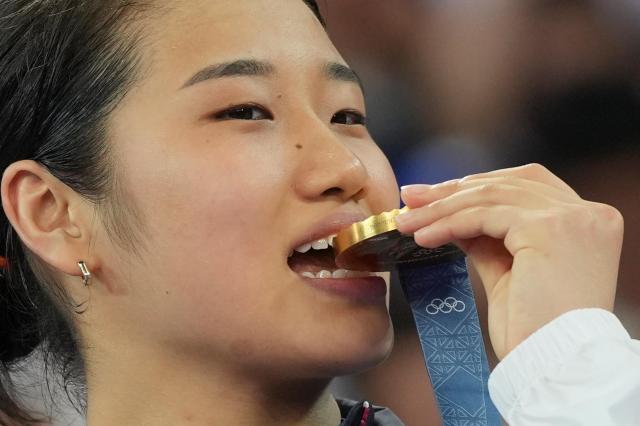 South Koreas An Se-young celebrates on the podium after wining the gold medal at the badminton women singles at the 2024 Summer Olympics Monday Aug 5 2024 in Paris AP-Yonhap