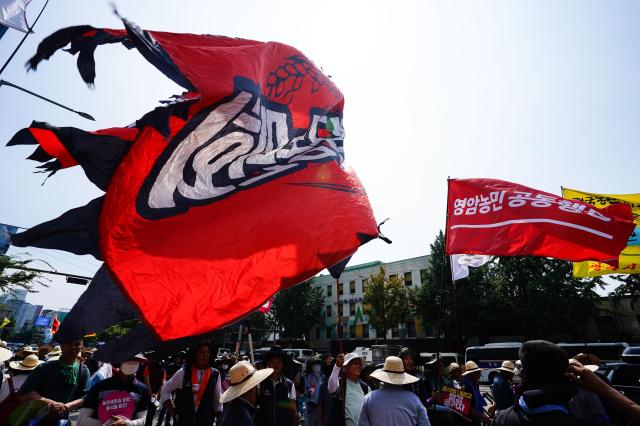 Flags of various farmers groups wave during a rally organized by the National Farmers Federation to demand guaranteed rice prices on Aug 6 2024 AJU PRESS Park Jong-hyeok