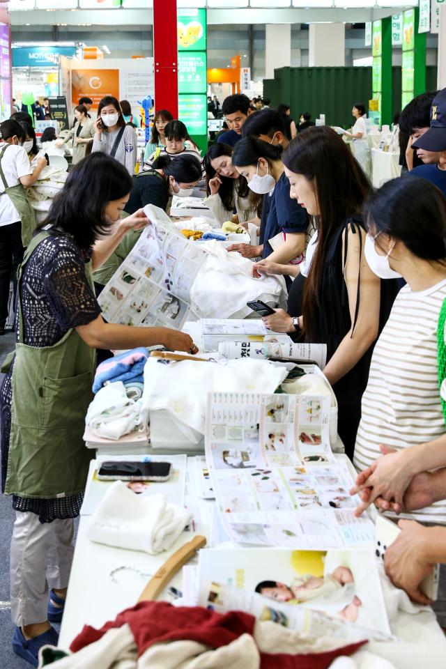 Visitors examine childcare products at the Global Baby Fair held at COEX in Seoul on Aug 8 2024 AJU PRESS Kim Dong-woo