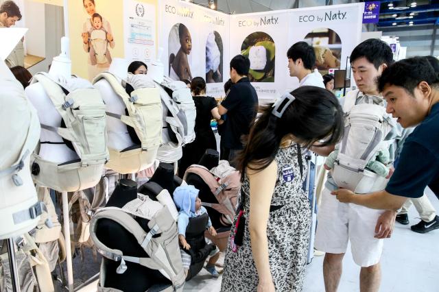 Visitors examine childcare products at the Global Baby Fair held at COEX in Seoul on Aug 8 2024 AJU PRESS Kim Dong-woo