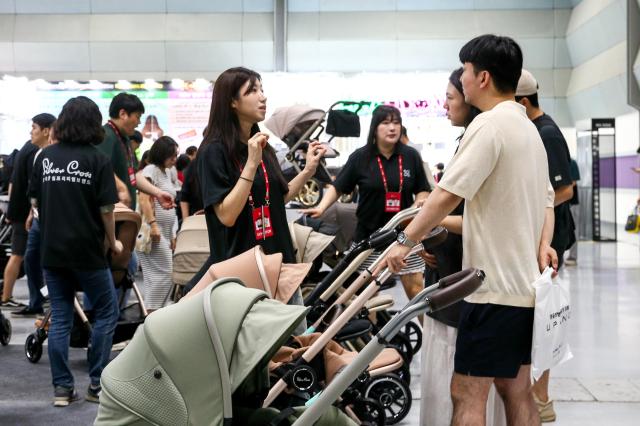 Visitors examine strollers at the Global Baby Fair held at COEX in Seoul on Aug 8 2024 AJU PRESS Kim Dong-woo