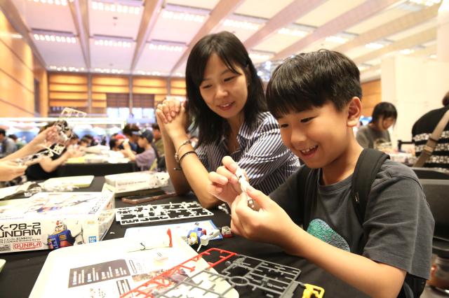 Visitors experience assembling plastic models at the Bandai Namco Korea FUN EXPO 2024 at COEX in Seoul on Aug 9 2024 AJU PRESS Han Jun-gu
