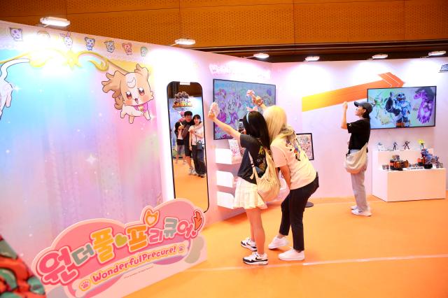 Visitors wear displayed wigs and take photos at the Bandai Namco Korea FUN EXPO 2024 at COEX in Seoul on Aug 9 2024 AJU PRESS Han Jun-gu