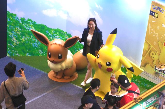 A visitor poses for a photo with Pokemon exhibits at the Bandai Namco Korea FUN EXPO 2024 at COEX in Seoul on Aug 9 2024 AJU PRESS Han Jun-gu