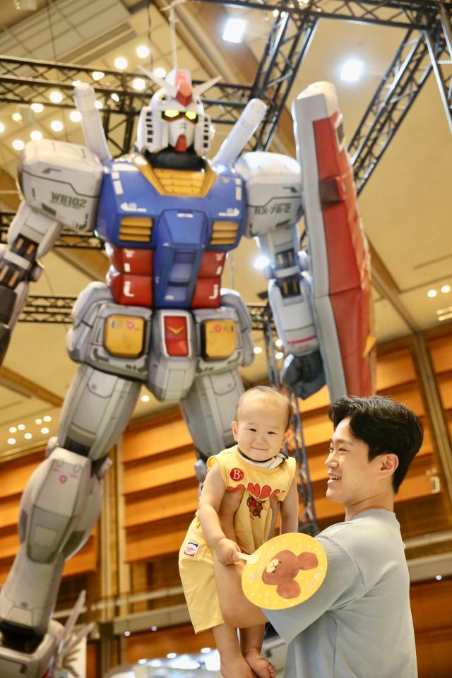 A baby and a man pose for a photo at the Bandai Namco Korea FUN EXPO 2024 at COEX in Seoul on Aug 9 2024 AJU PRESS Han Jun-gu