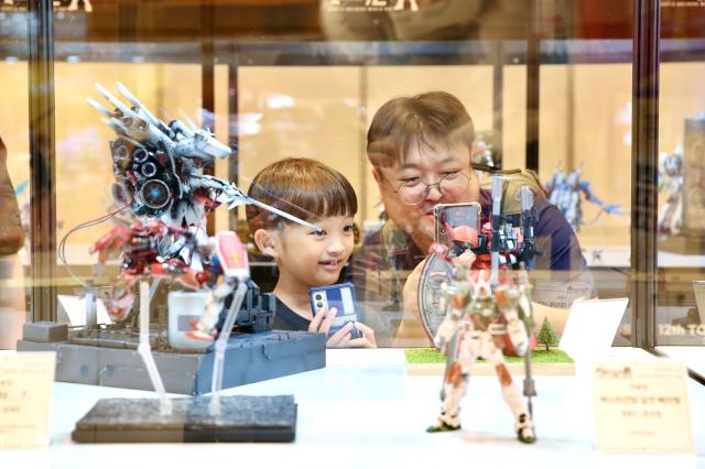 Visitors take photos of robot exhibits at the Bandai Namco Korea FUN EXPO 2024 at COEX in Seoul on Aug 9 2024 AJU PRESS Han Jun-gu