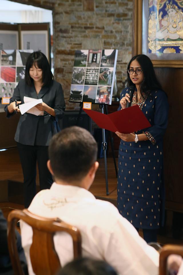 Aditi Kumar right welcomes guests during a photo exhibition held at the Indian Ambassador to the Republic of Koreas residence near central Seoul on August 10 Aju Press Park Sae-jin