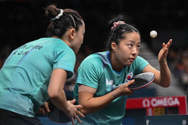 South Koreas Shin Yu-bin R prepares to serve as Jeon Ji-hee L looks on during their womens table tennis doubles match in the team bronze medal event between South Korea and Germany at the Paris 2024 Olympic Games at South Paris Arena in Paris on Aug 10 2024 AFP-Yonhap