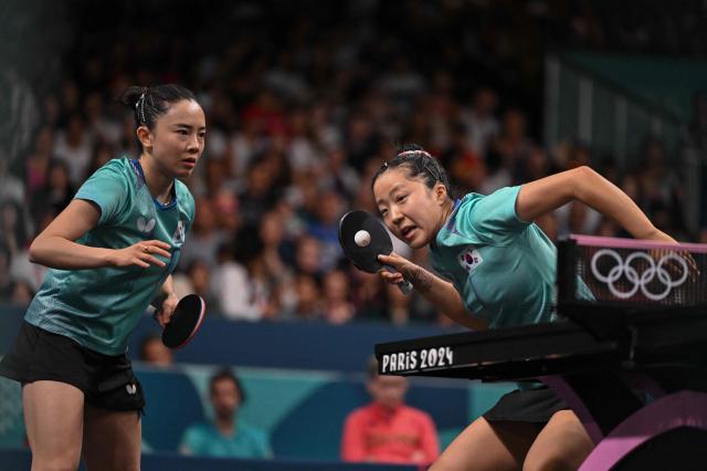 South Koreas Shin Yu-bin R returns the ball as South Koreas Jeon Ji-hee L looks on during their womens table tennis doubles match in the team bronze medal match between South Korea and Germany at the Paris 2024 Olympic Games at the South Paris Arena in Paris on Aug 10 2024 AFP-Yonhap