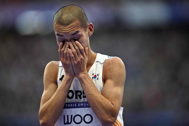 South Koreas Woo Sang-hyeok reacts as he competes in the mens high jump final of the athletics event at the Paris 2024 Olympic Games at Stade de France in Saint-Denis north of Paris on Aug 10 2024 AFP-Yonhap 