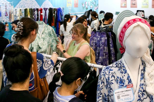 Visitors examine hanbok at the Hanbok Expo held at Dongdaemun Design Plaza in Seoul on Aug 9 2024 AJU PRESS Kim Dong-woo