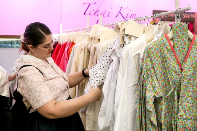 A visitor examine hanbok at the Hanbok Expo held at Dongdaemun Design Plaza in Seoul on Aug 9 2024