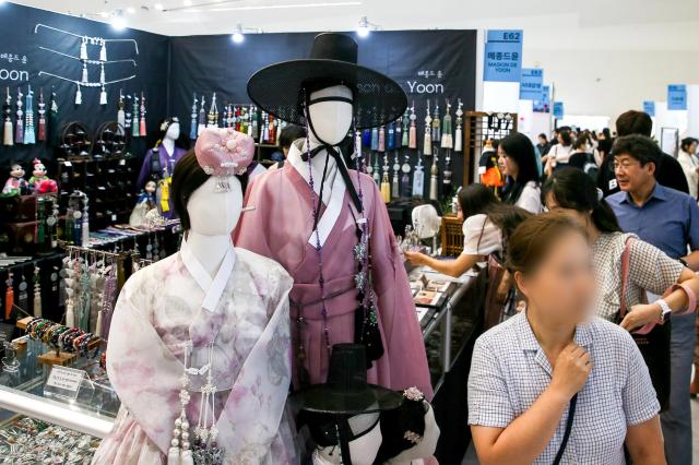 Visitors examine hanbok at the Hanbok Expo held at Dongdaemun Design Plaza in Seoul on Aug 9 2024 AJU PRESS Kim Dong-woo