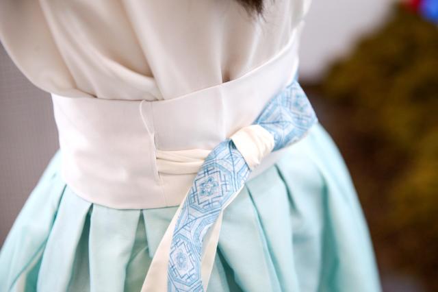 A visitor tries on hanbok at the Hanbok Expo held at Dongdaemun Design Plaza in Seoul on Aug 9 2024