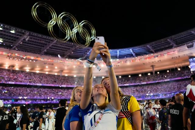 Athletes take a selfie during the closing ceremony of the 2024 Summer Olympics at Stade de France in Saint-Denis France on August 12 2024 AP-Yonhap