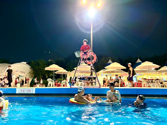 A lifeguard watches over people from a ladder at the swimming pool in Han River Park Yeouido Seoul on August 9 2024 AJU PRESS Han Jun-gu