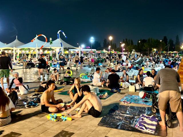 Visitors take a rest in the relaxation area next to the swimming pool at Han River Park Yeouido Seoul on August 9 2024 AJU PRESS Han Jun-gu