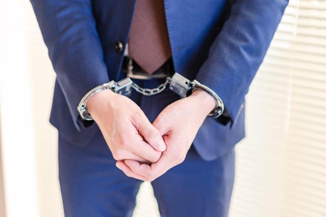 A man in cuffs Getty Images Bank