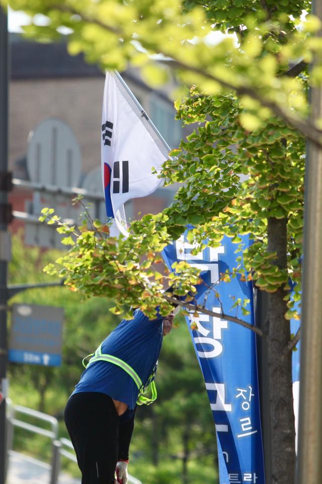 A worker hangs the national flag of Korea on a utility pole in Jongno-gu Seoul ahead of Liberation day of Korea on August 14 2024 AJU PRESS Han Jun-gu