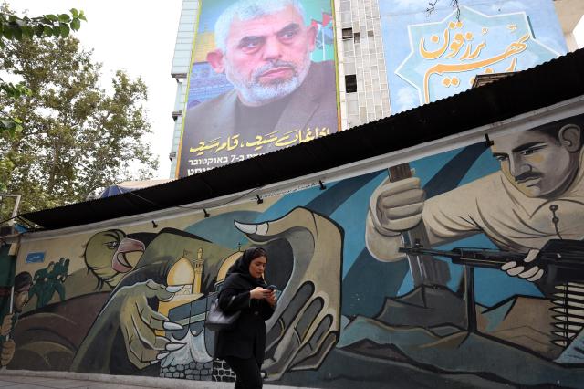 A pedestrian passes by a picture of new Hamas leader Yahya Sinwar at Palestine Square in Tehran Iran on Aug 12 2024 EPA - Yonhap