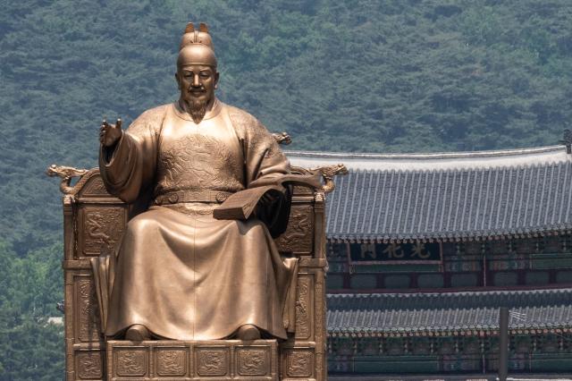 The Chinese sign for Gwanghwamun is seen beyond the statue of King Sejong the Great AJU PRESS Park Jong-hyeok