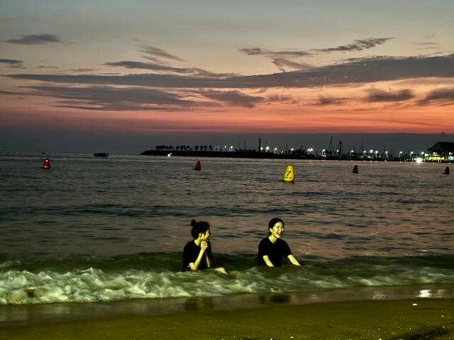 Visitors sit in shallow water at Wangsan Beach in Incheon on Aug 11 AJU PRESS Han Jun-gu
