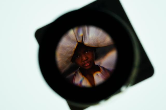 Magnified view of original film through a loupe at For Every Children exhibit marking 30 years of The Korean Committee for UNICEF Sejong Center Aug 16 2024 AJU PRESS Park Jong-hyeok