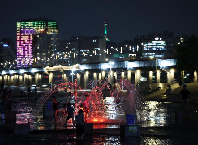 People cool off at a Han River park in Seoul on Aug 16 2024 Yonhap