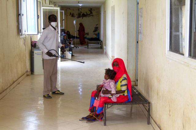 A man sanitizes a rural isolation center where cholera patients are receiving treatment in eastern Sudan on Aug 17 2024 AFP - Yonhap