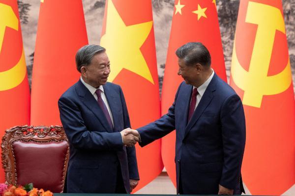 Vietnams top leader To Lam left shakes hands with Chinese President Xi Jinping at the Great Hall of the People in Beijing on Monday Reuters-Yonhap