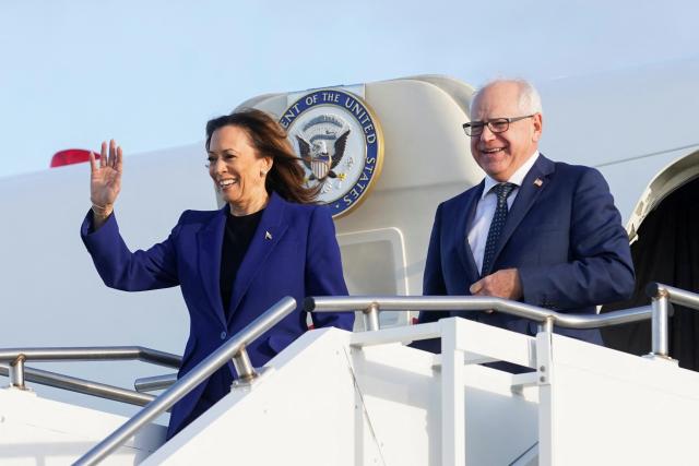 Democratic presidential candidate and US Vice President Kamala Harris along with her running mate Minnesota Governor Tim Walz step off Air Force Two on August 20 2024 at Milwaukee Mitchell International Airport in Milwaukee Wisconsin ahead of a campaign rally